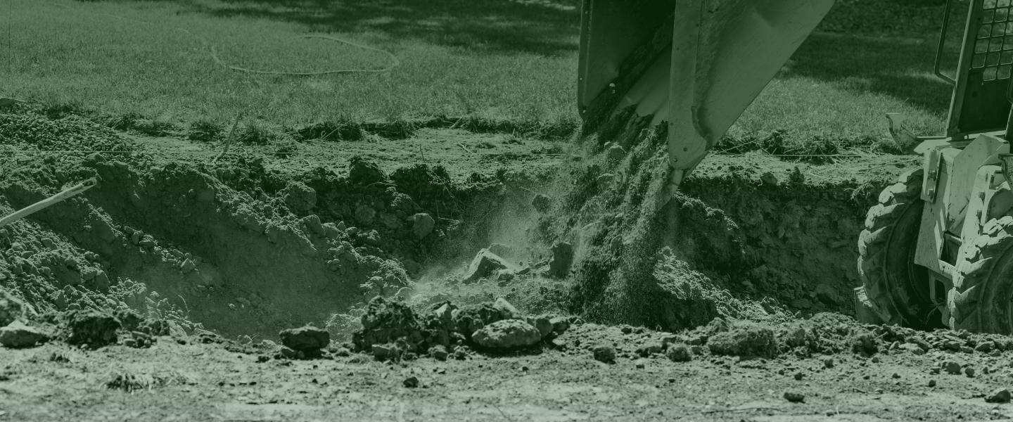 closeup of a claw of an excavator putting dirt into land foreshill ca