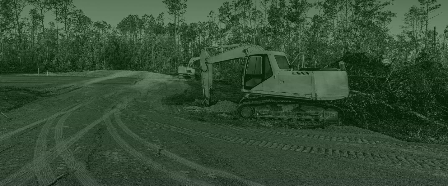 image of an excavator clearing land debris from ground foresthill ca