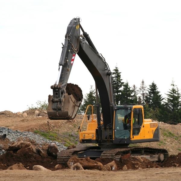 image of an excavator scooping dirt from the ground foresthill ca